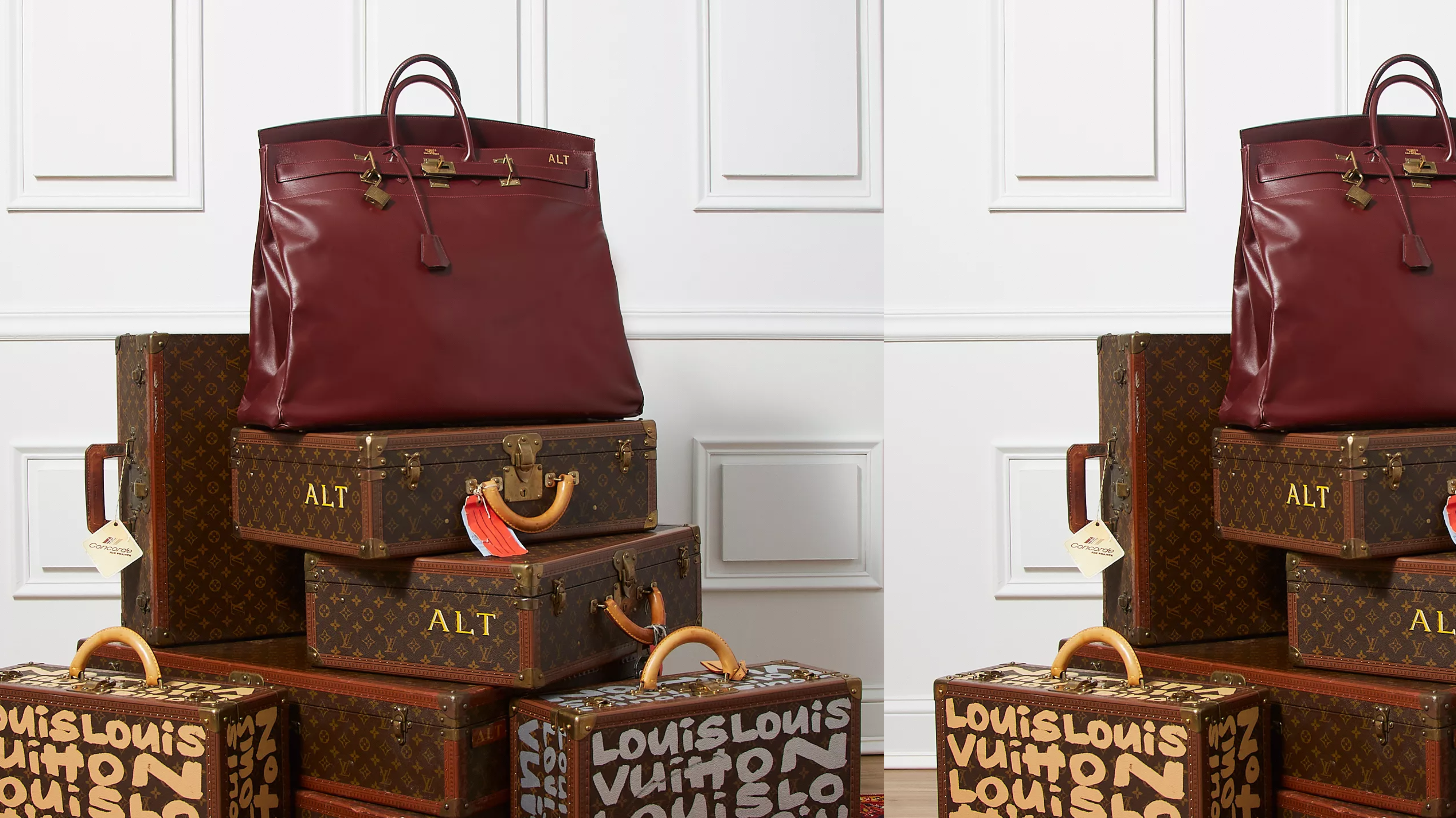 Large vintage Hermès Haut à Courroies handbag displayed on stacked Louis Vuitton trunks, illustrating the importance of proper storage and preservation for luxury bags.